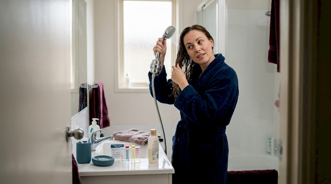 Woman rinsing hair with filtered shower water